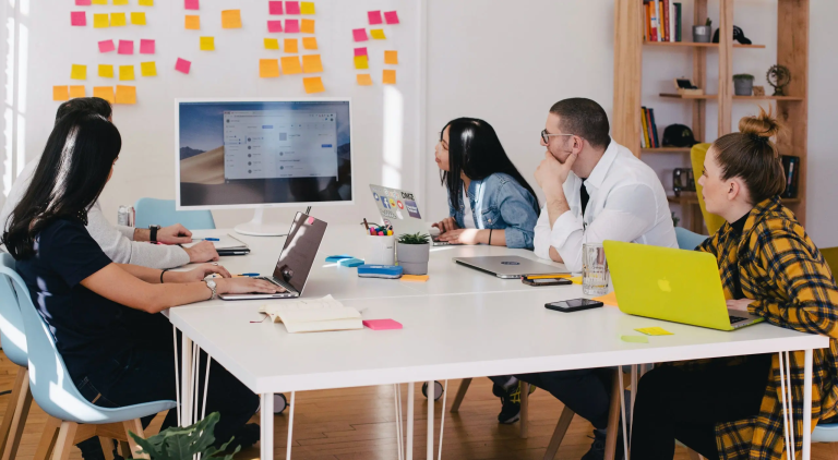 Business team collaboration meeting with professionals watching a digital presentation in a modern office